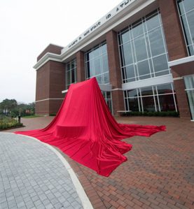 unveiling cloth red large statue unveil